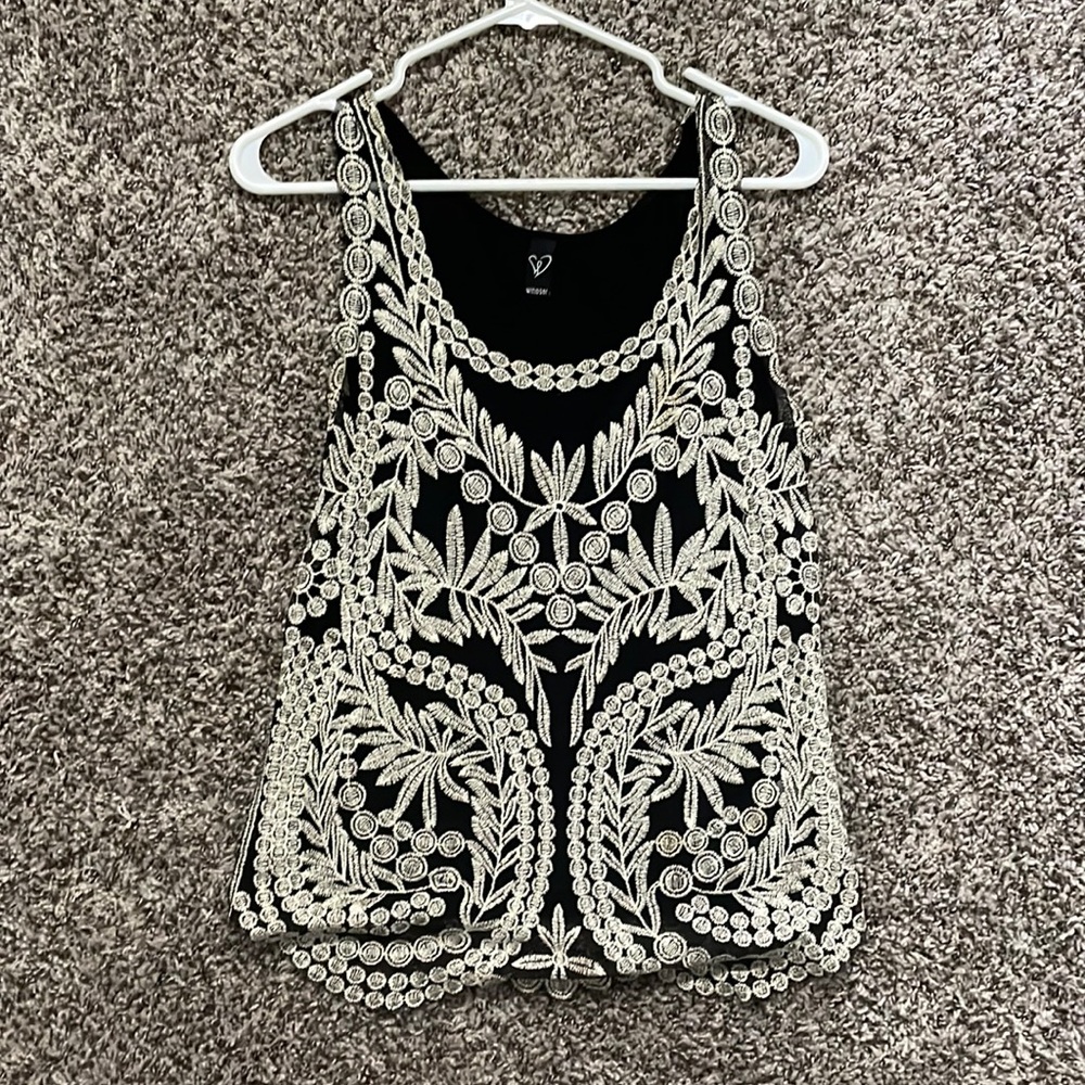 Flattering tank top. Slight discoloration on left chest area . Loose fitting